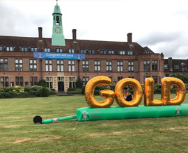 Gold banner on the lawn in front of HCA building